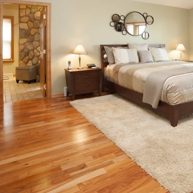 bedroom with wood flooring and carpet rug