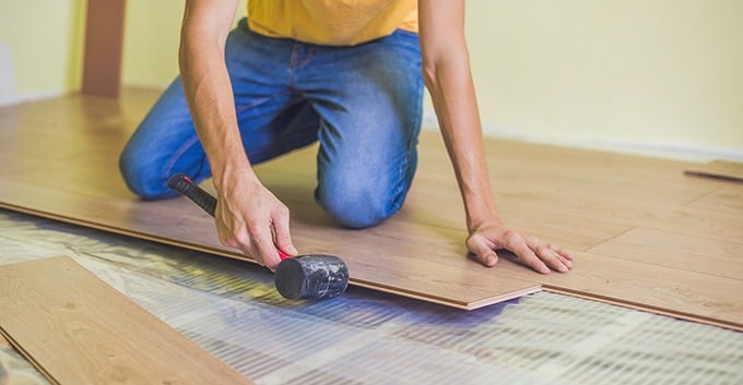 man installing hardwood flooring