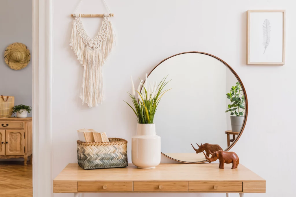 Stylish composition of creative spacious living room interior with mock up poster frame, mirror, commode, plants and accessories. White walls and parquet floor. Template
