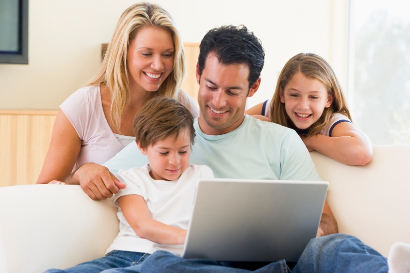 Family on couch with laptop