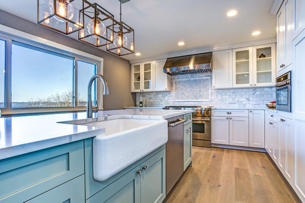 Kitchen with Blue Cabinets and Large Windows