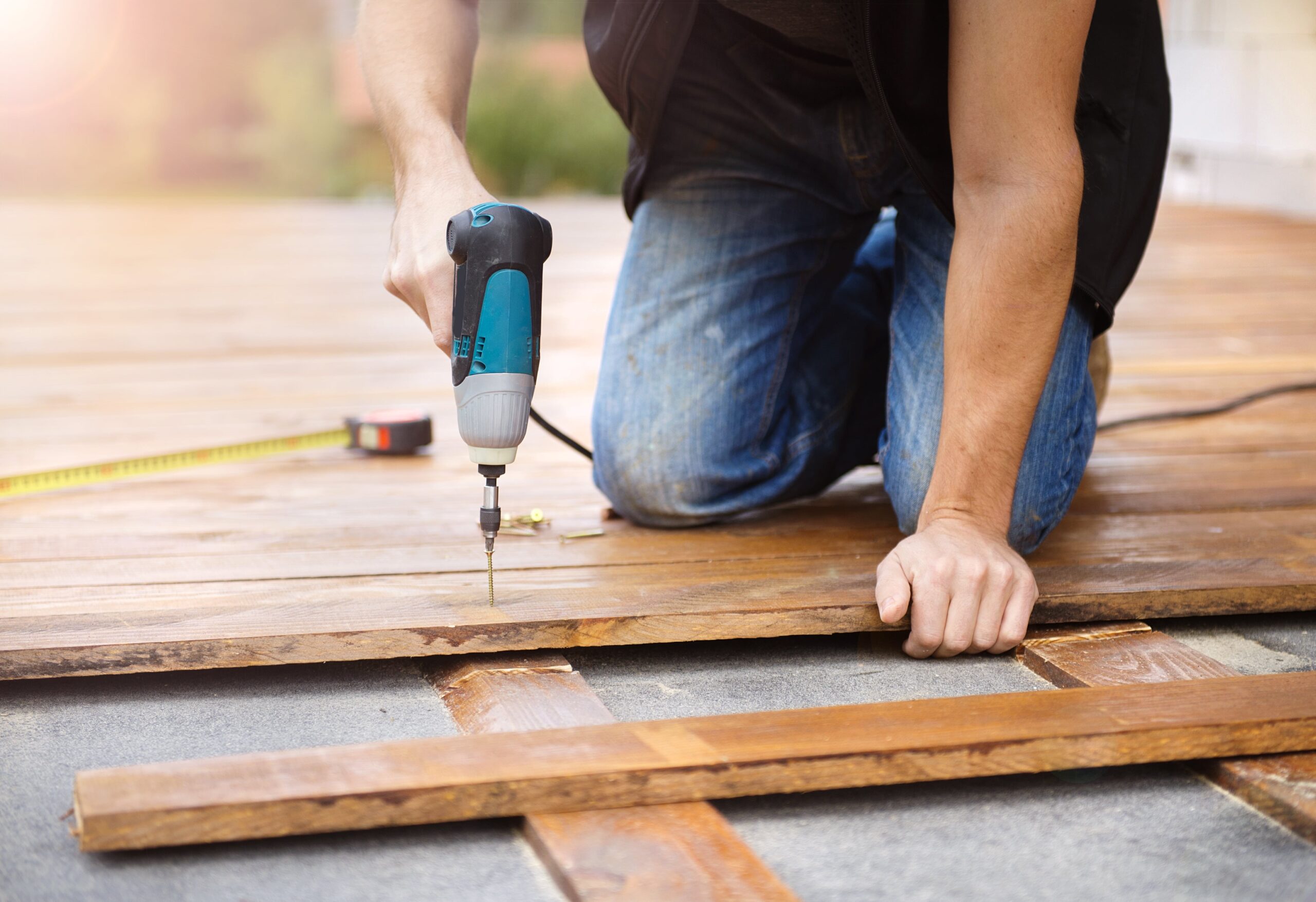 man installing wood floors