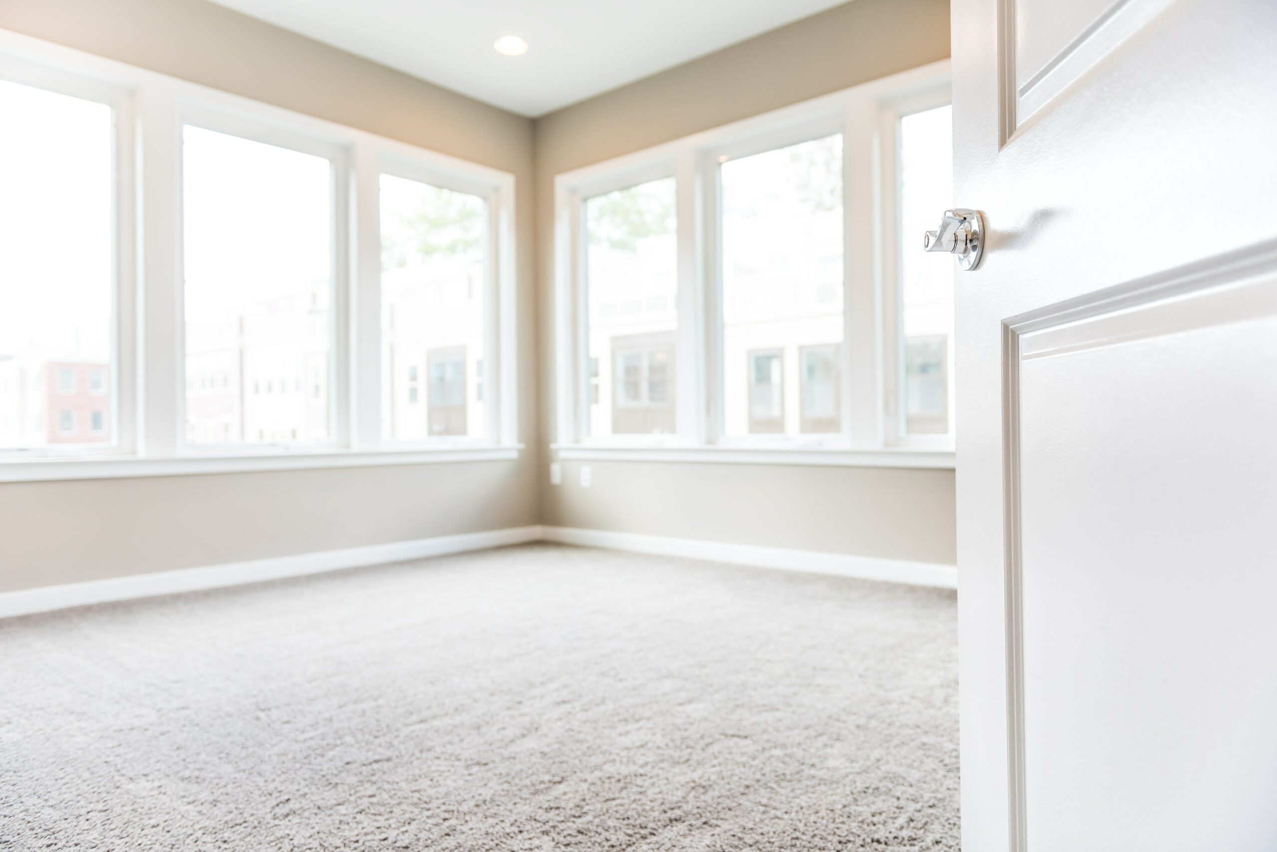 empty bedroom with light carpet flooring