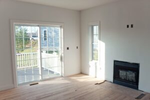 flooring in living room with fireplace and glass door leading to patio