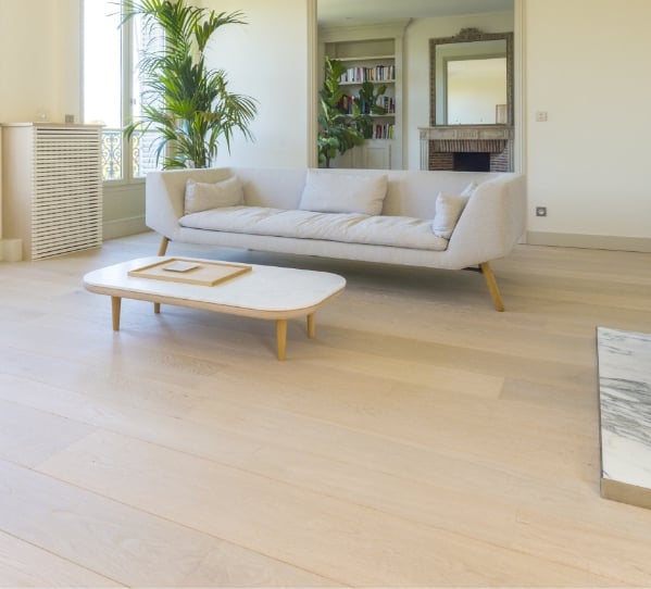 Light wood floors with cream couch and coffee table