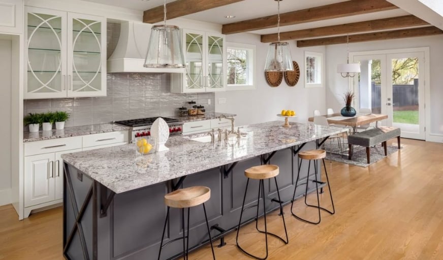 Kitchen with dark cabinets on island and light wood floor