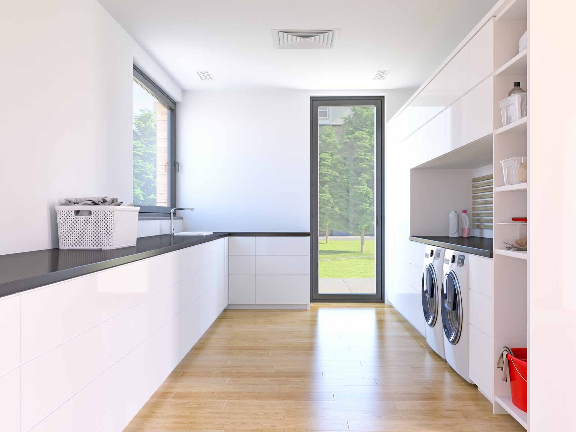 laundry room with wood floors and white cabinets