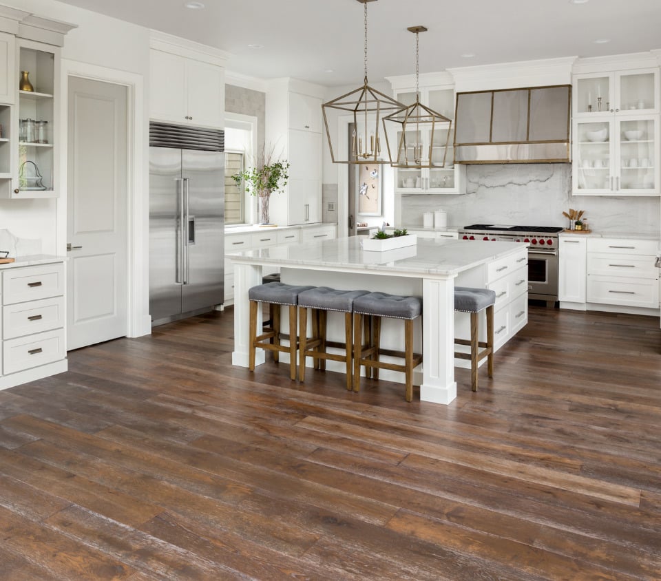 White cabinet kitchen and island with wood floors