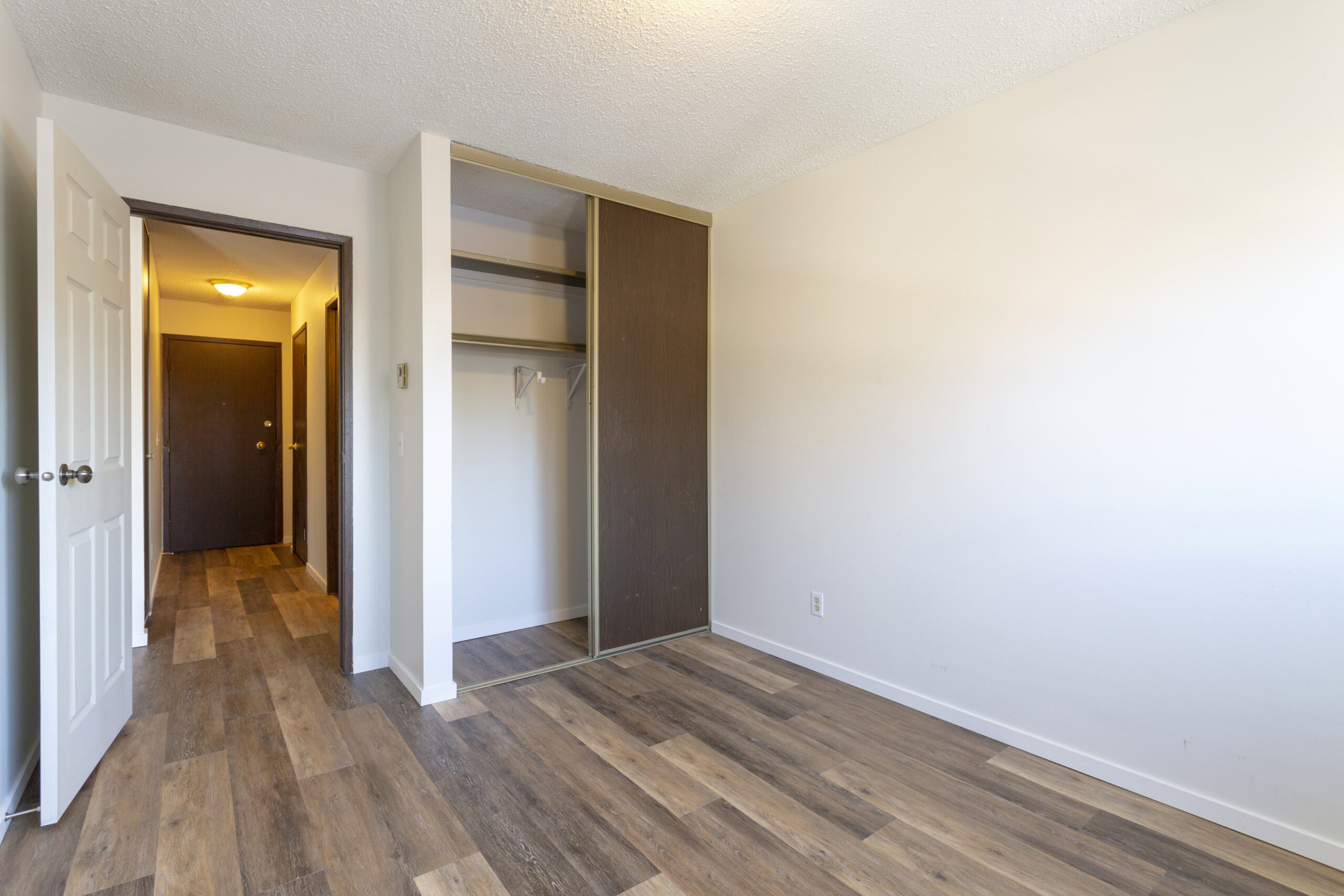 bedroom, closet and hallway with vinyl floors