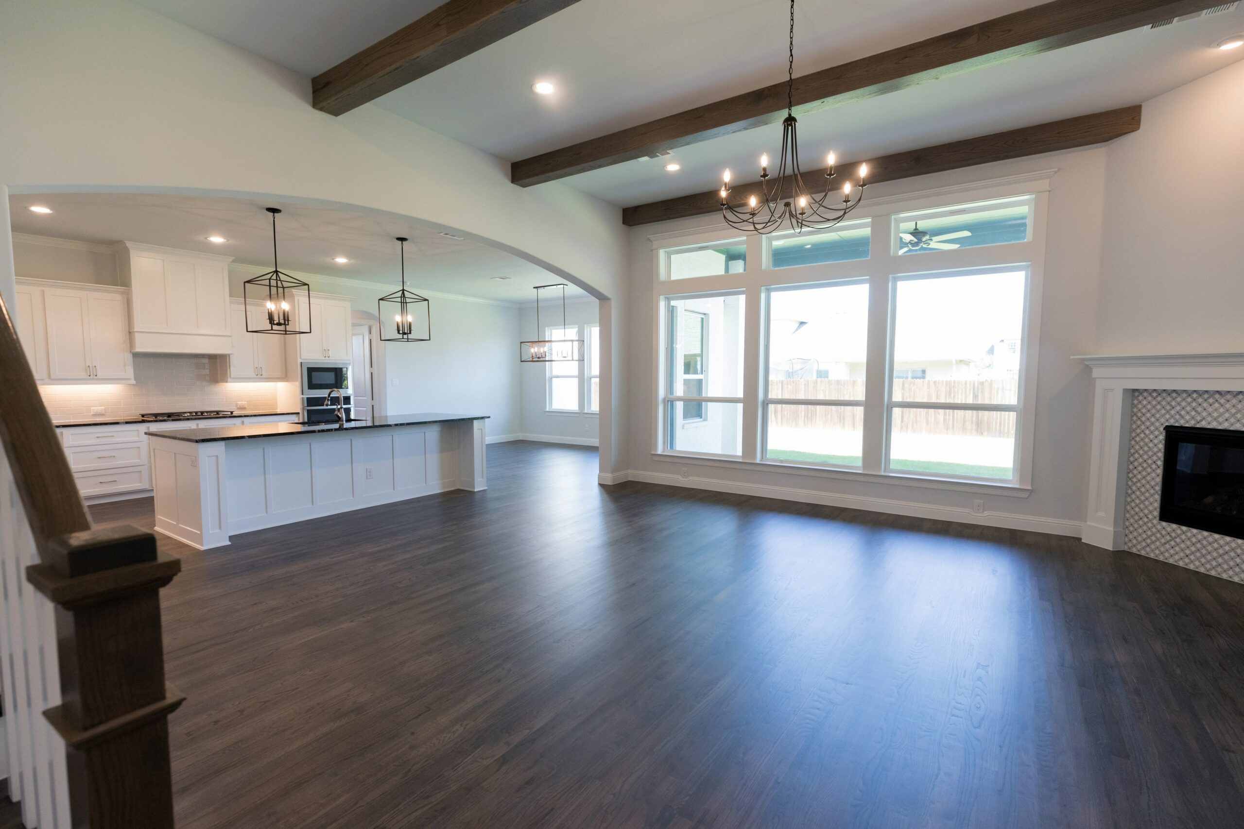 Open floor plan kitchen and living room with dark vinyl floors