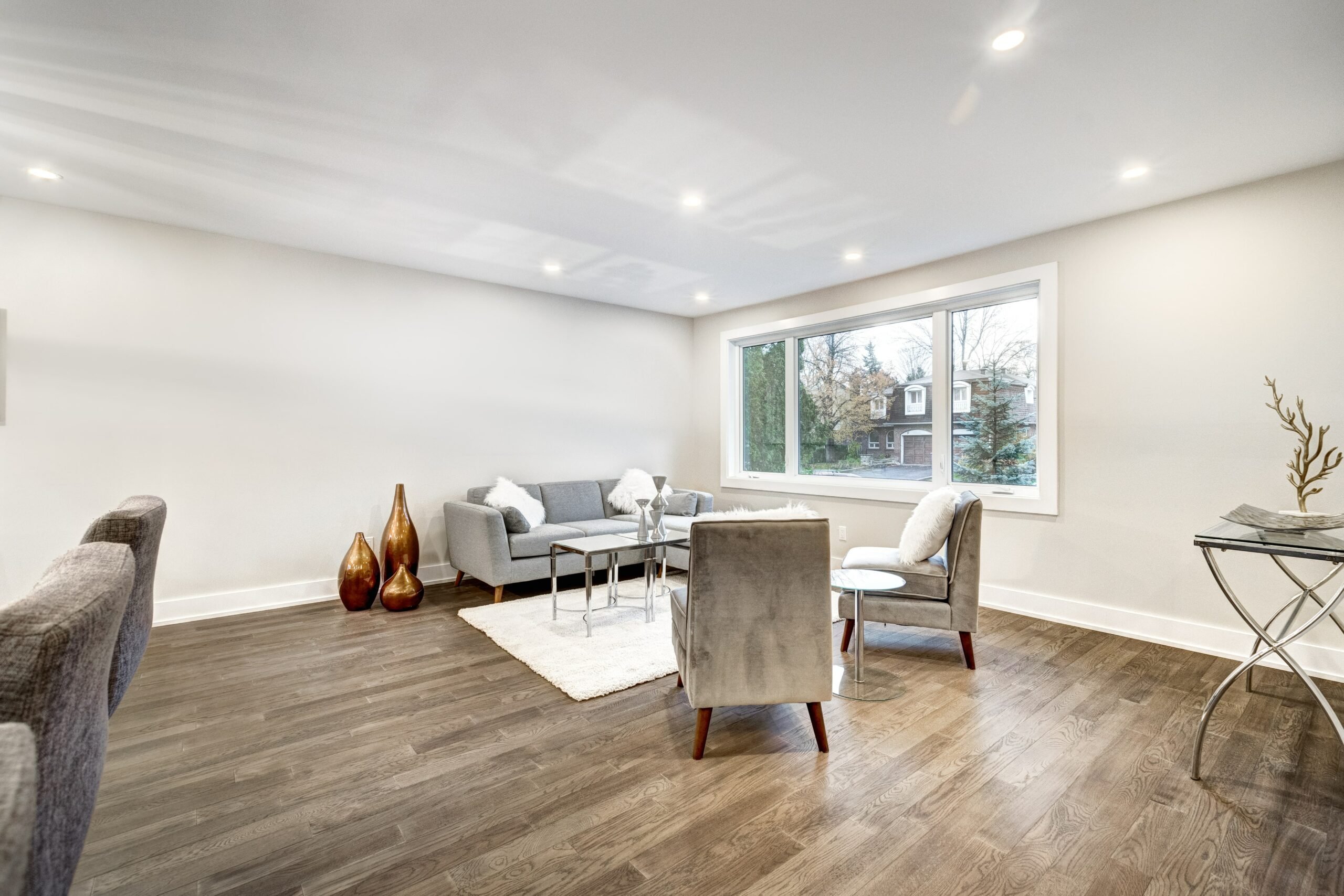 Room with wood floors, couch and white walls