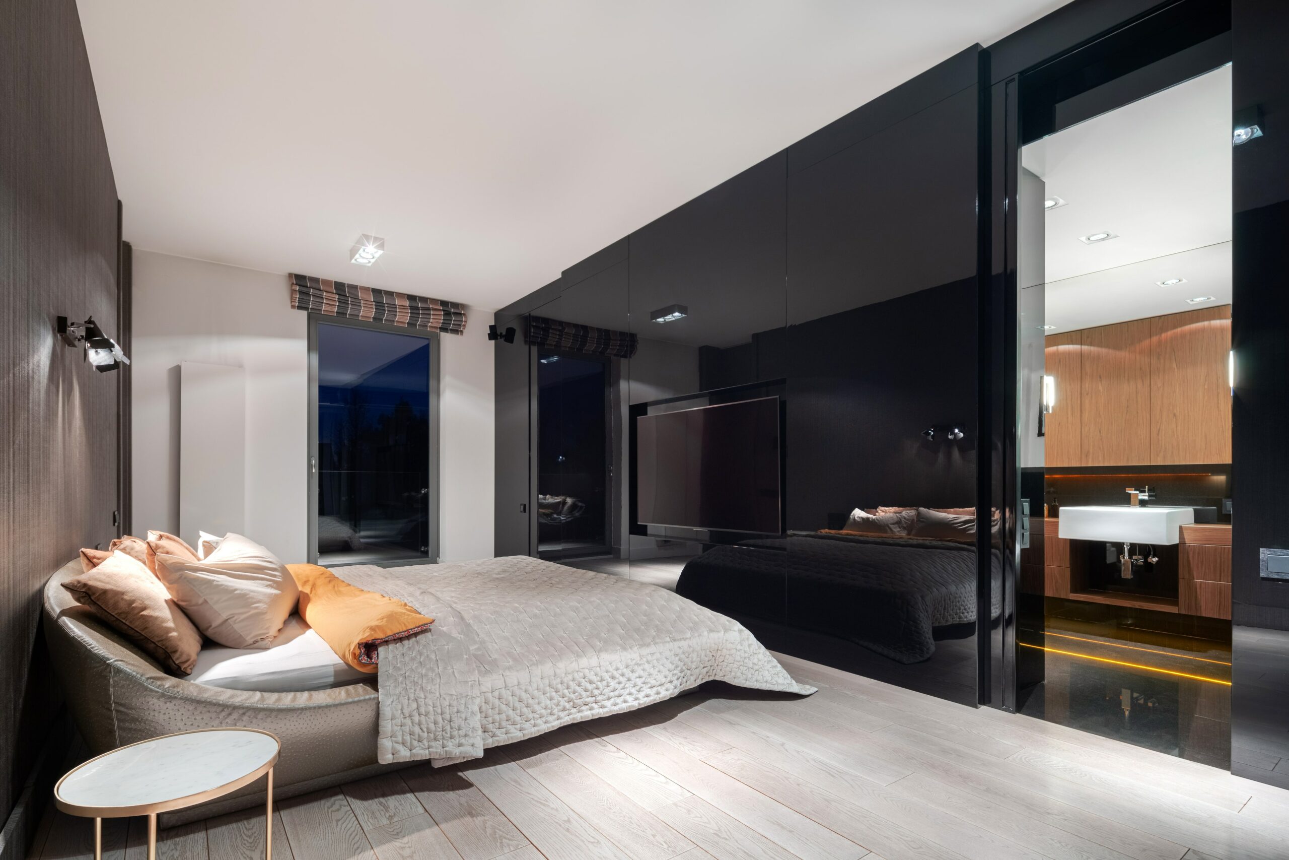 Bedroom with black wall and light wood floors