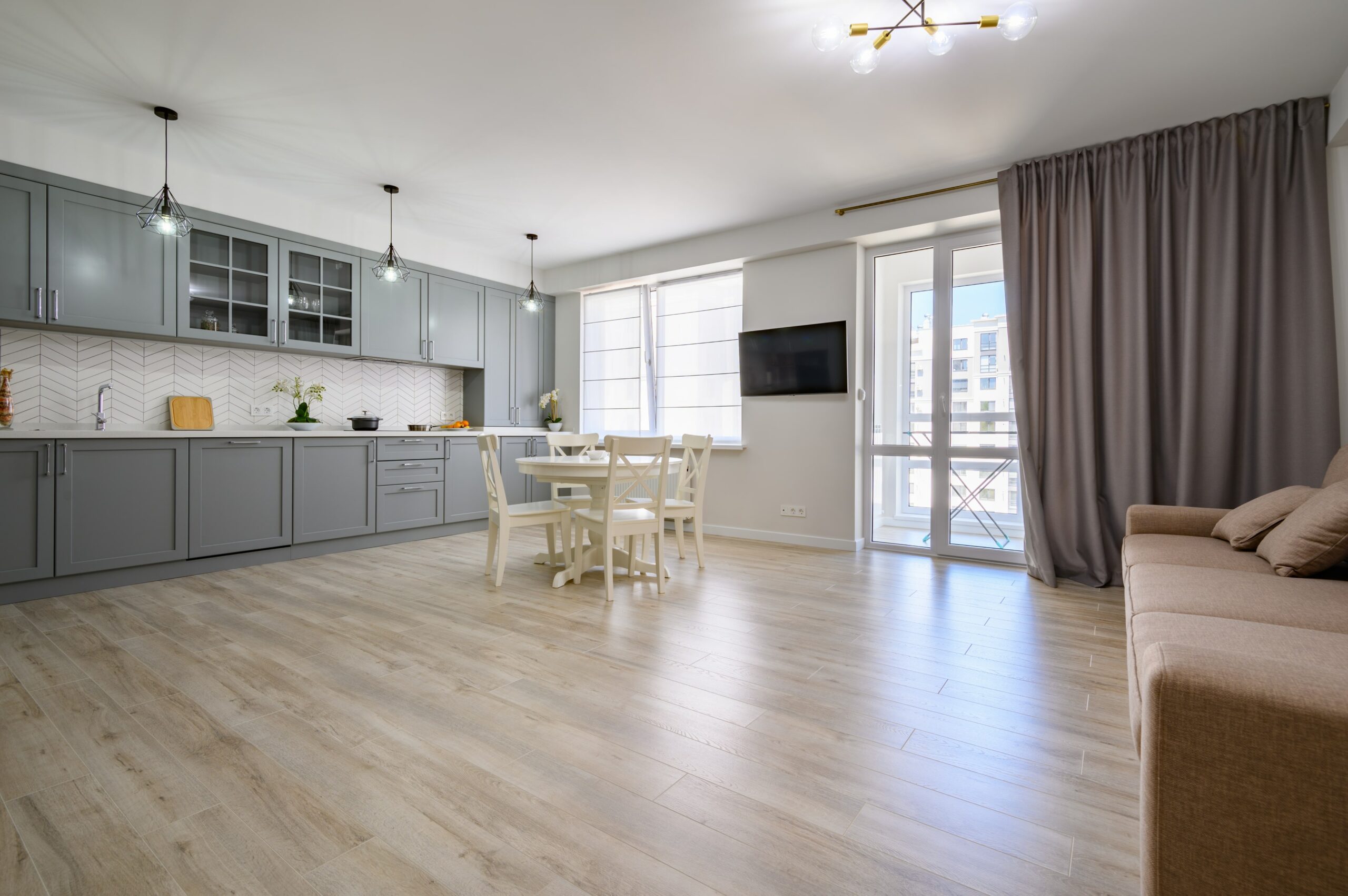 Apartment with light floors and gray cabinets