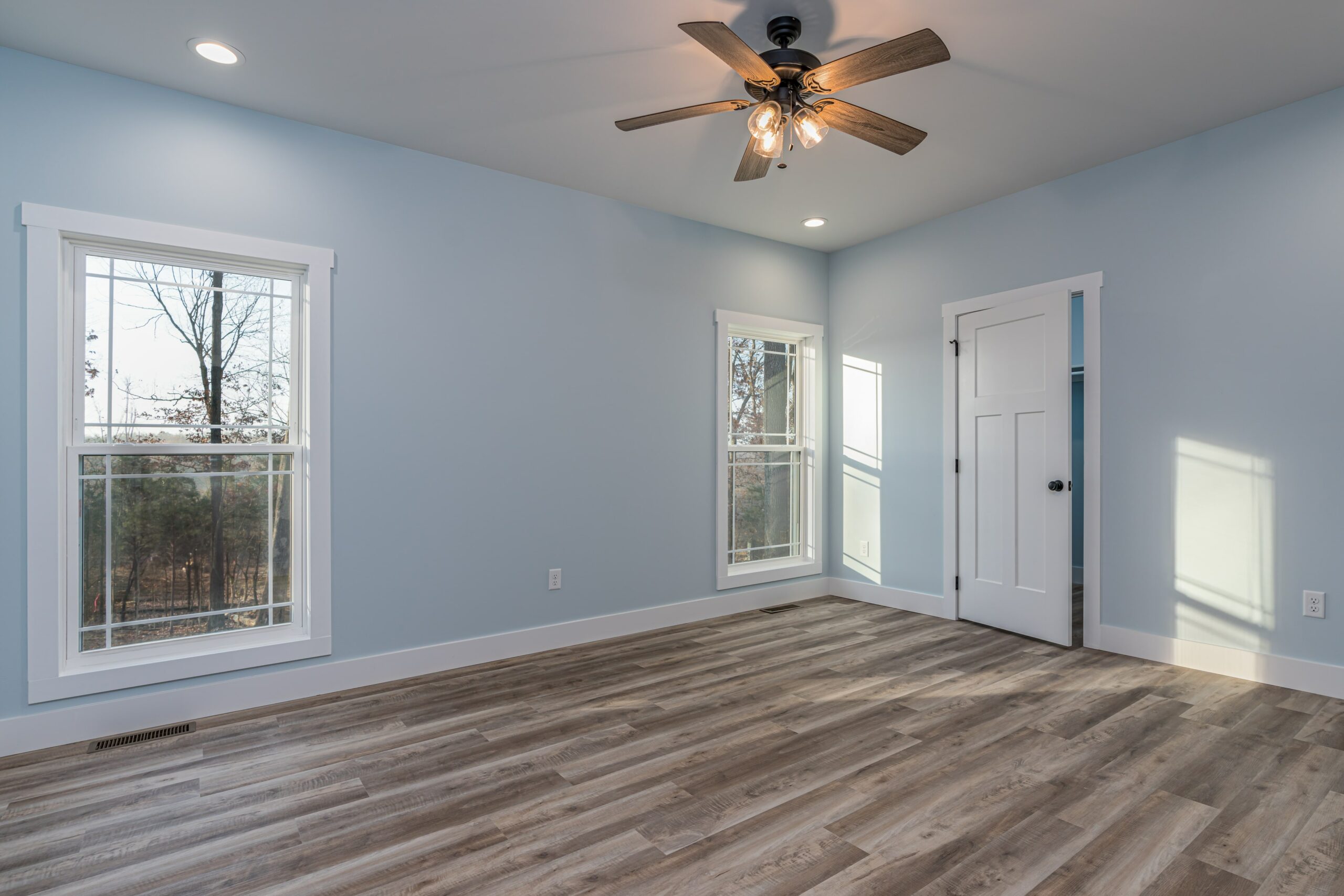 bedroom with wood floors and light blue walls