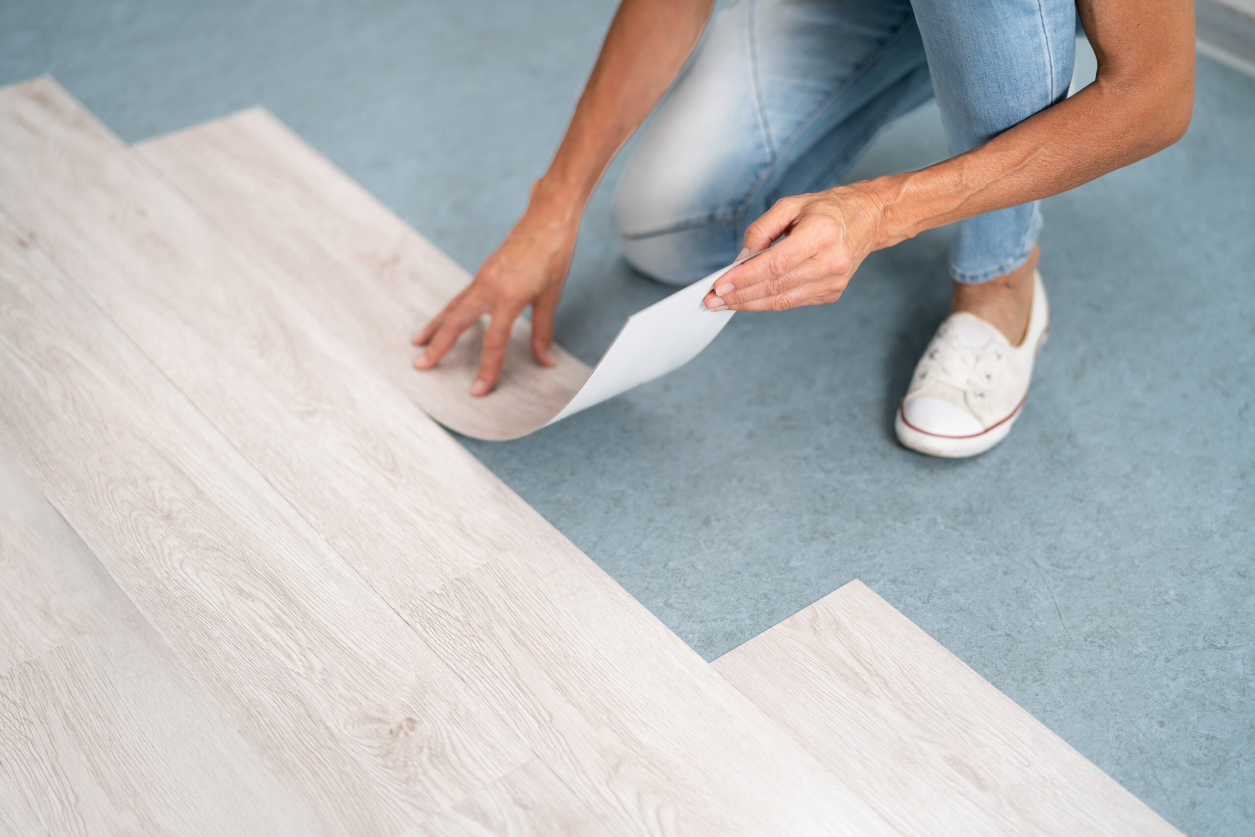 Person laying down vinyl flooring