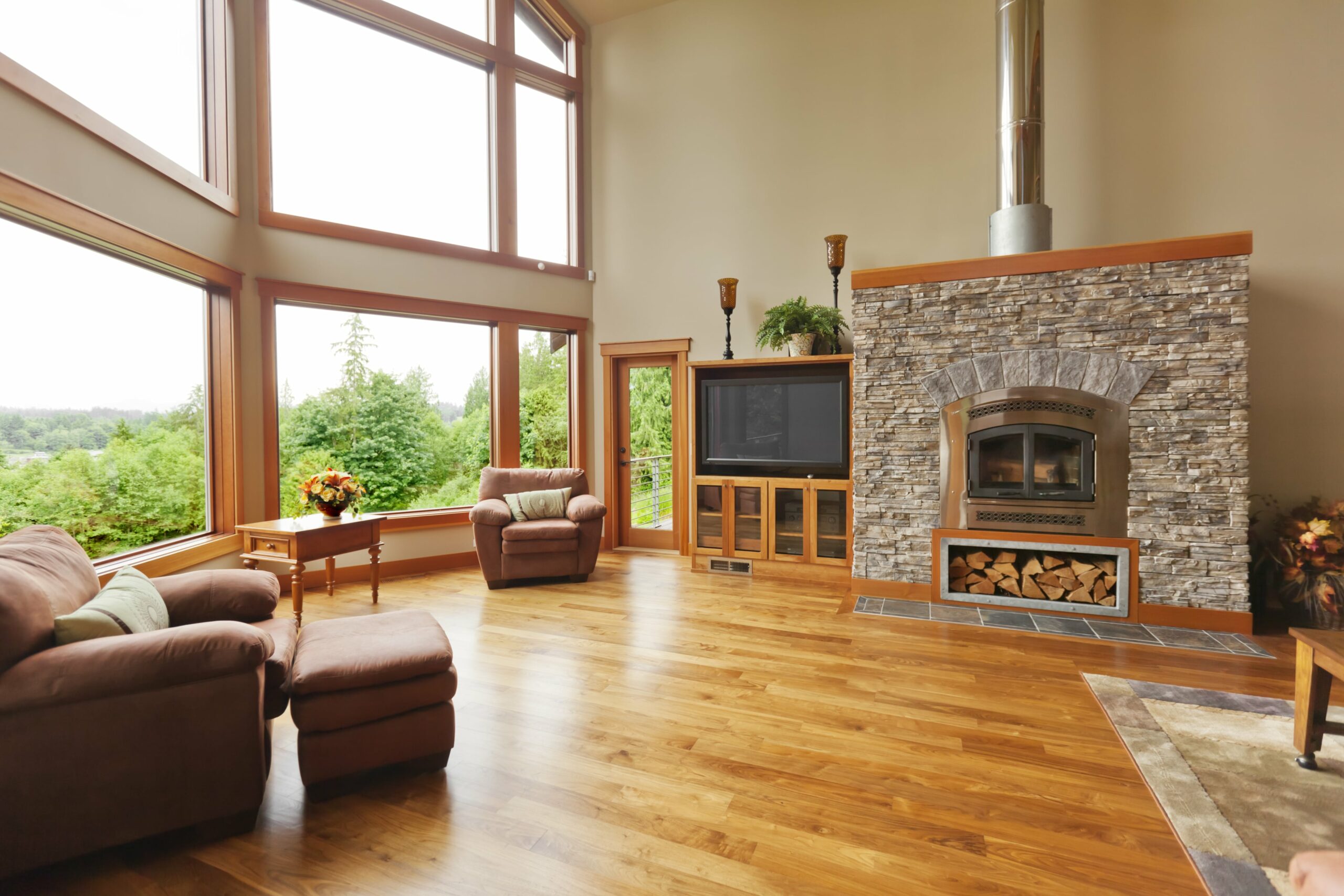 home with wood floors and stone fireplace