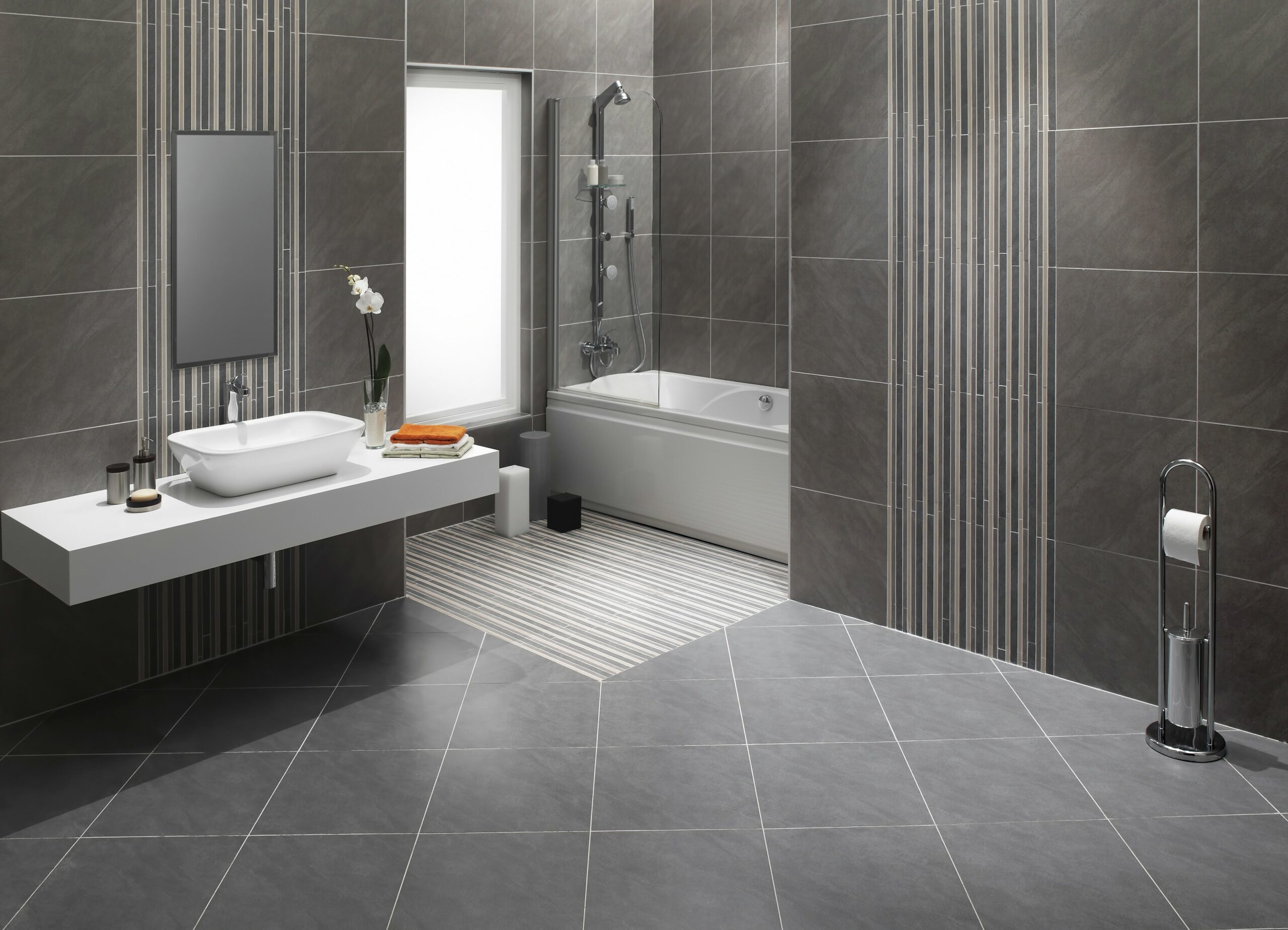 bathroom with grey tile floors and walls