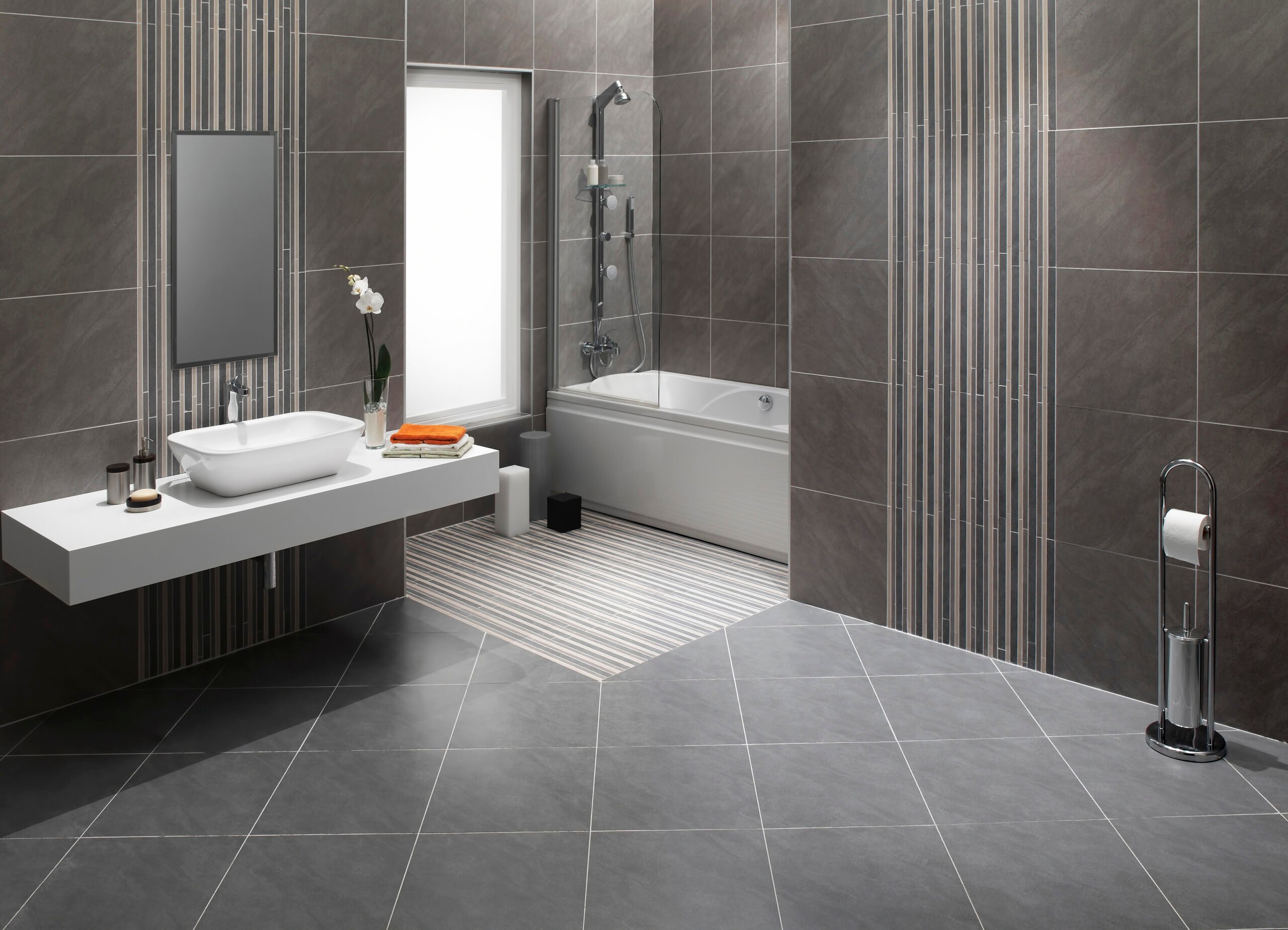 bathroom with grey tile flooring and walls