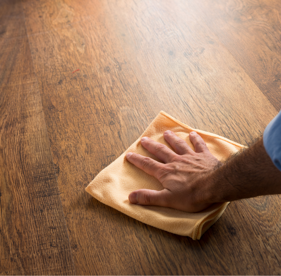 Hand cleaning hardwood floors with cloth