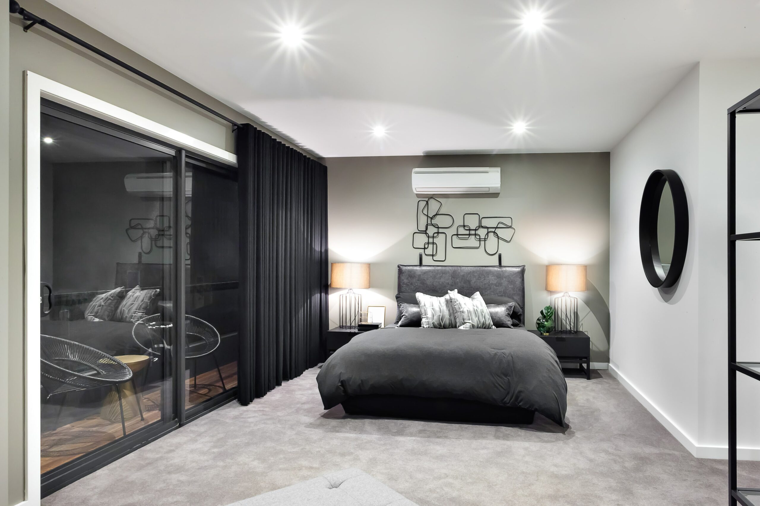 Bedroom with white carpet and bed with grey bedding