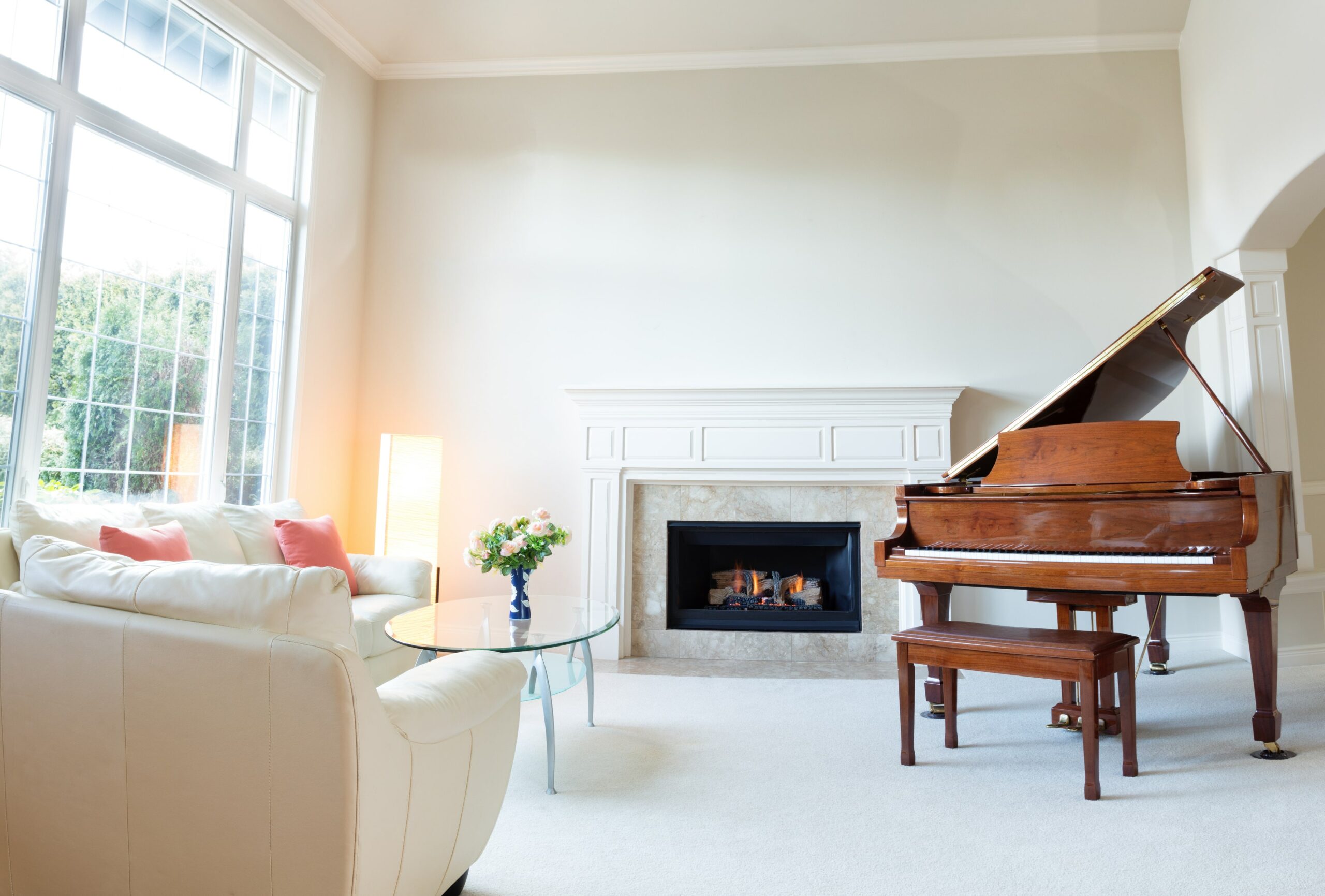 Room with carpet, piano and fireplace