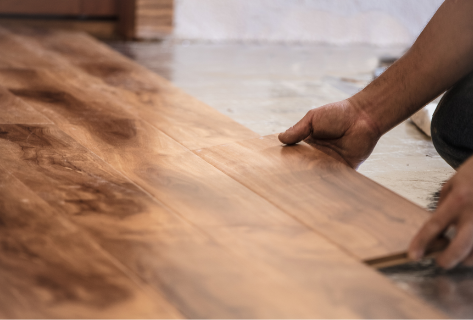 person installing wood flooring