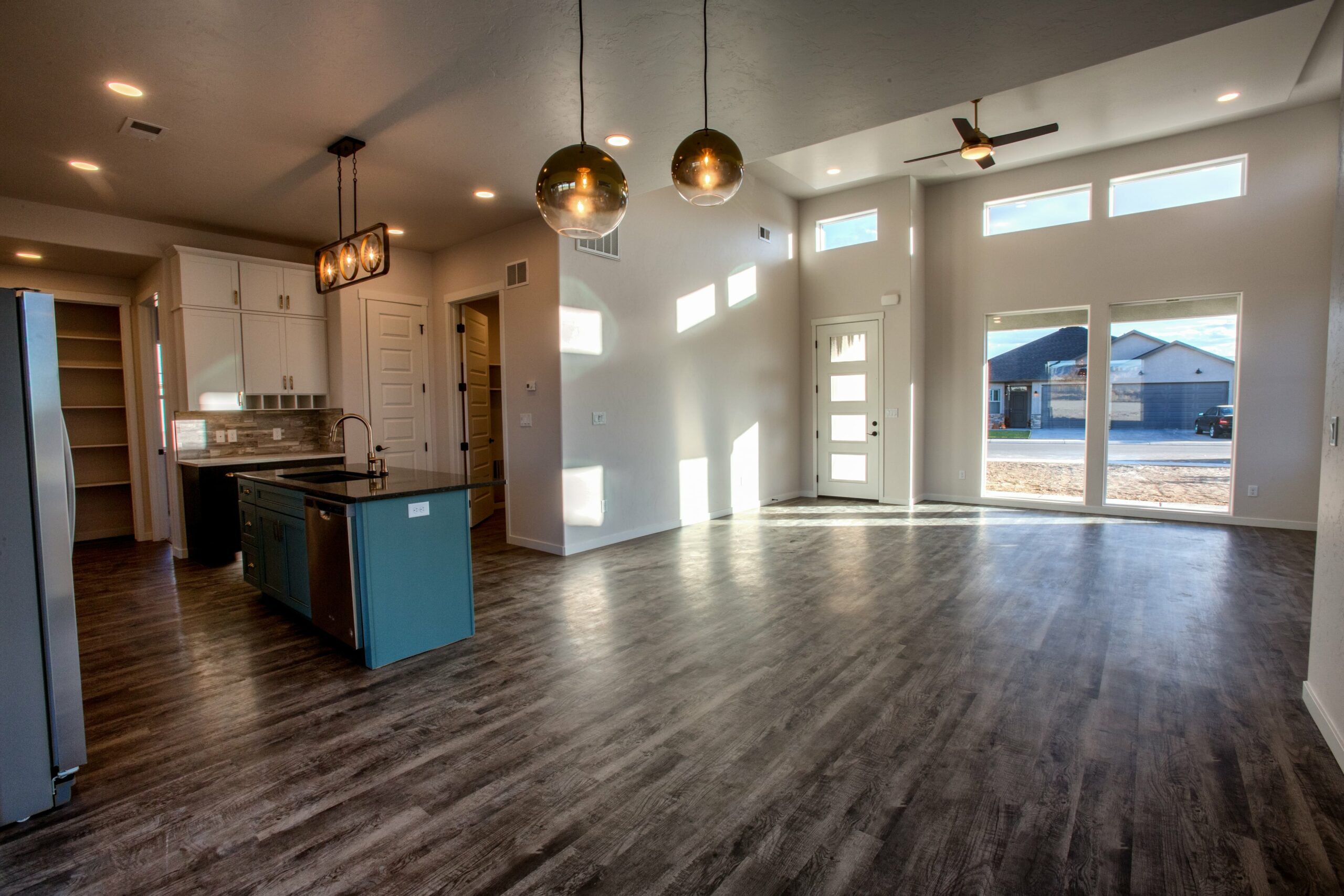 Engineered wood flooring in kitchen with blue cabinet island